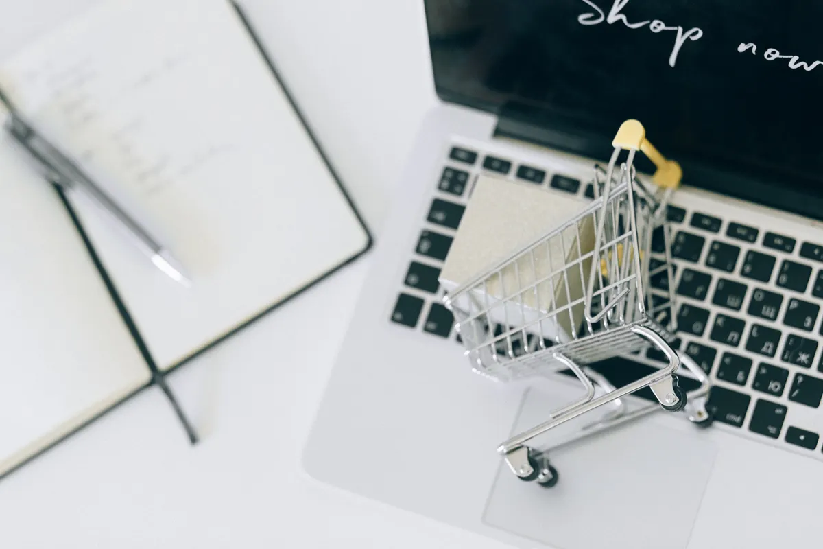 Miniature shopping cart on a laptop keyboard